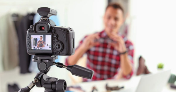 Male blogging into video camera